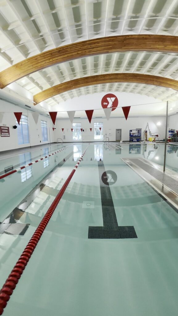 East Valley YMCA natatorium, wide view of the pool and wood beam ceiling